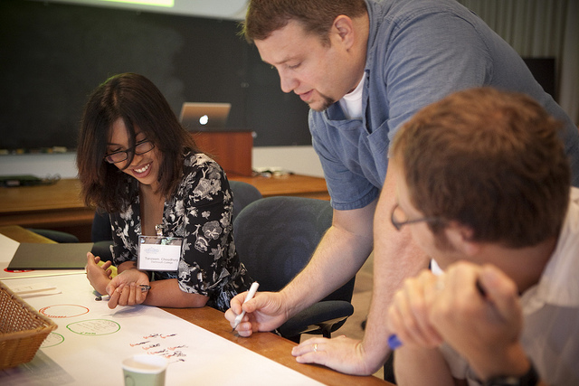 Image of three students working together.