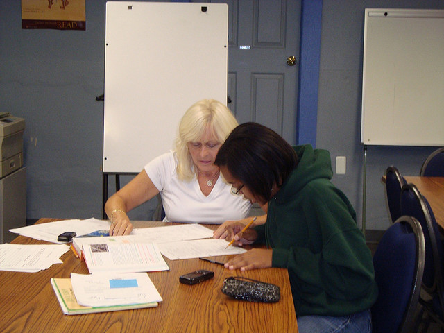 A student at office hours, meeting with her professor