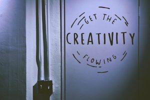 Writing on a wall that says "Get the creativity flowing"