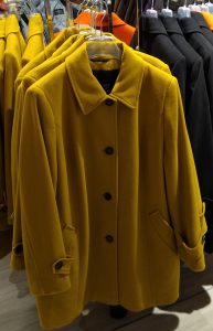 yellow coat with black buttons
