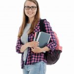 Paula holding books and wearing a backpack