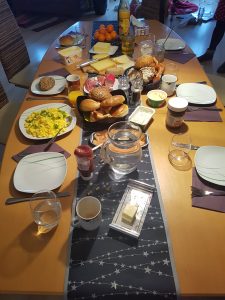 breakfast table with all types of cheese, sausage, bread, etc