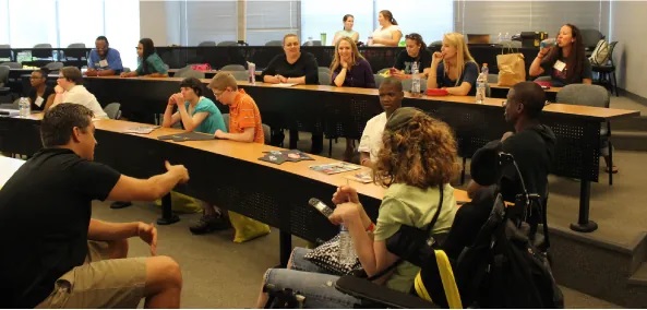 A photograph shows college-age students in a classroom.