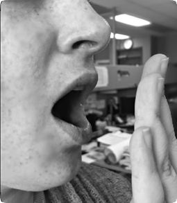 Hand in front of mouth