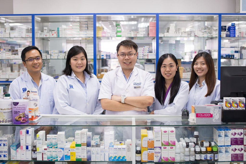 A pharmacist and pharmacy technologists in a pharmacy