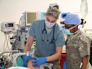 Anesthesiologist providing care with another care provider to a patient