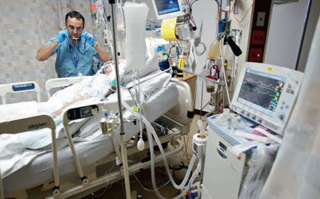Respiratory therapist proving care to patient on a ventilator