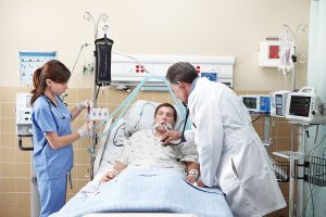 Patient in ICU with physician providing care