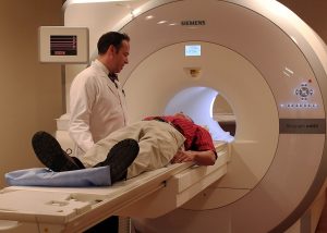 Patient laying down and about to go into an MRI