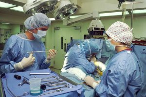 Operating room with a medical professional completing a surgical procedure