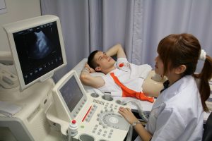 Patient being given an ultrasound of their abdomen