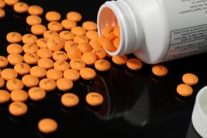Bottle and tablets of regular strength enteric coated aspirin tablets