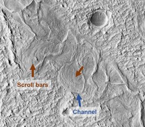 Figure 8.2.4: A sinuous channel in the Aeolis Planum region of Mars taken by the HiRISE camera on the Mars Reconnaissance Orbiter. Blue arrow indicates the sinuous channel-like form, and orange arrows indicate areas with scroll bars (curved ridges).
