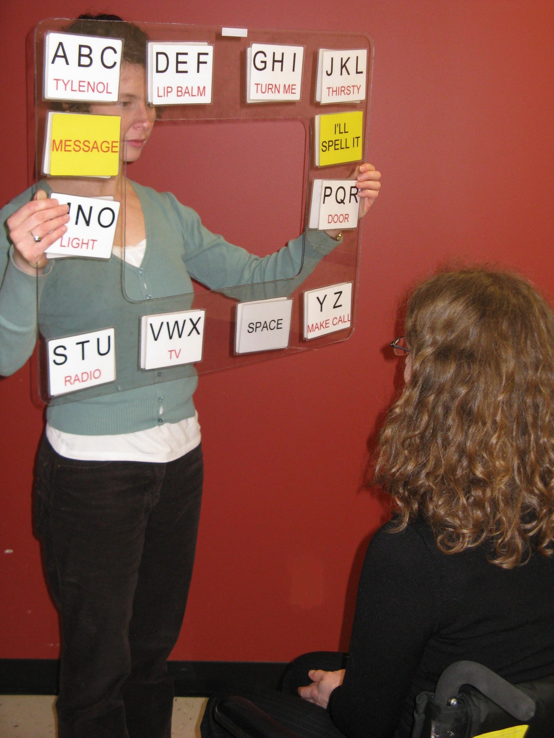 Descriptive image showing a presenter holding a sign as her visual aid. (10.1.0)