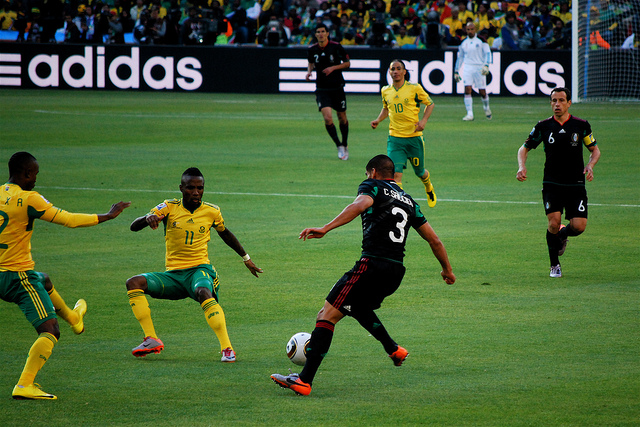 Descriptive image showing a professional soccer match between Mexico and South Africa. (13.3.1)