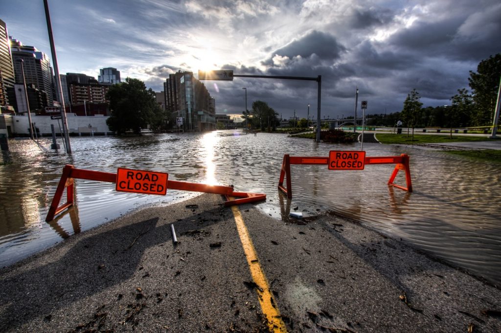 Descriptive image showing a road closed due to flooding.