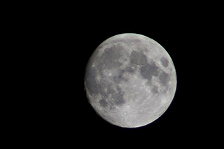 A photograph shows the full moon.