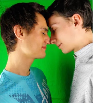 Two young men touch foreheads and noses.