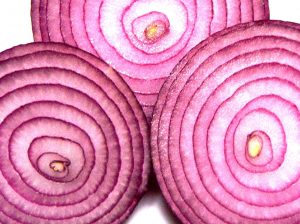 Three red onion slices displayed showing the inner layers