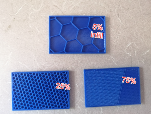 A photo of three 3D printed models, all with hexagonal infill patterning. The first model was printed with 5% infill and its hexagons are larger than the other two models. The second model was printed with 25% infill and its hexagons are smaller than the 5% model. The third model is printed at 75% infill the hexagons are very tiny.