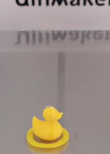 A picture of a small 3D printed duck with a circular ring around its perimiter