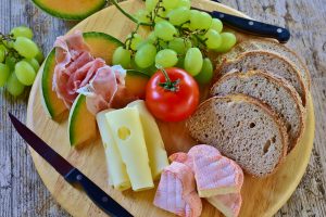 Bread board with cheese, meat and fruit