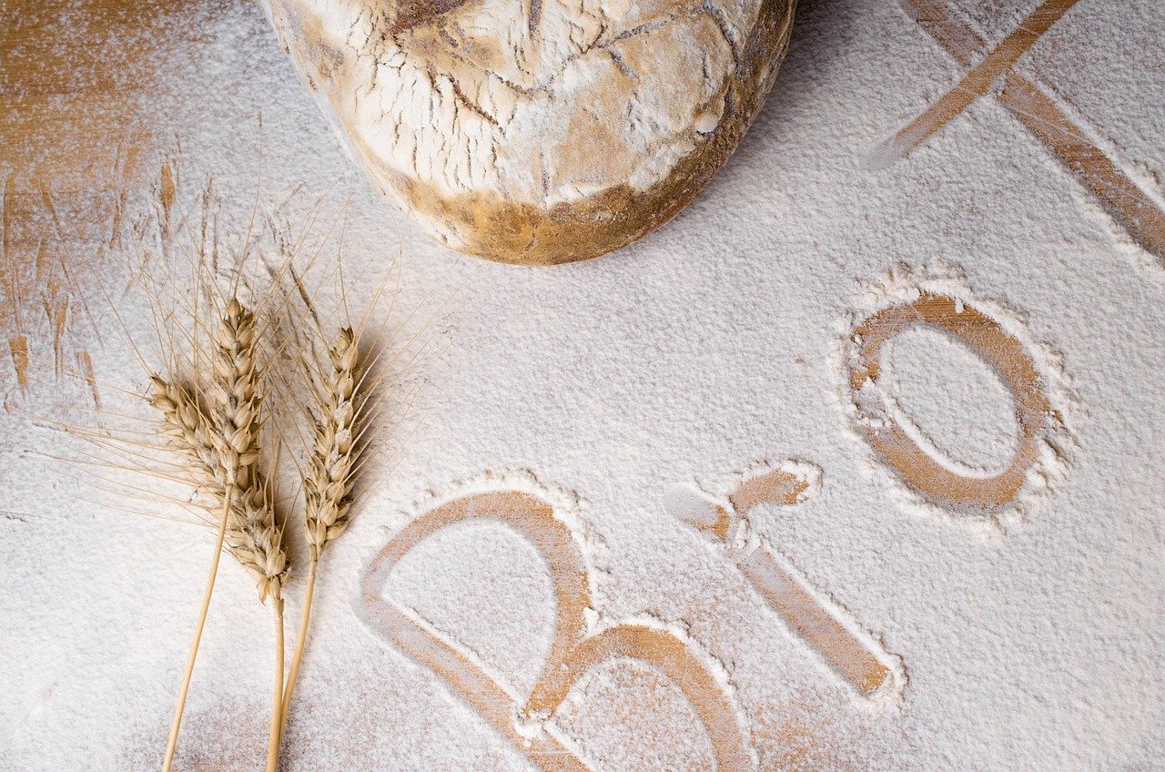 Brot written in flour and a loaf of bread