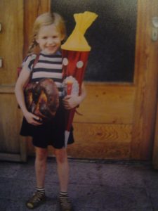little girl starting school holding her school cone